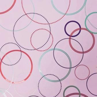 Gift wrapping paper colored circles on a lilac matte metallic background.
 